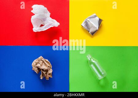 Trash sorting concept. Four colors background for sorting metal, glass. paper and plastic. Top View. Separate storage and disposal of waste for the Stock Photo