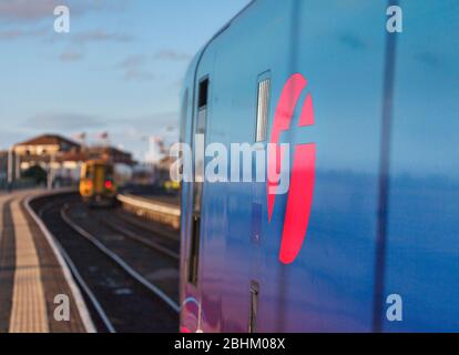 Northern rail class 158 train departing with a Firstgroup  logo on a Transpennine Express class 185 in the foreground at Blackpool North Stock Photo