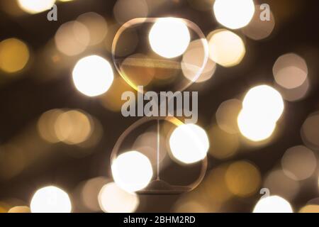 Hourglass on a background of blurry city lights, abstract photo. Stock Photo