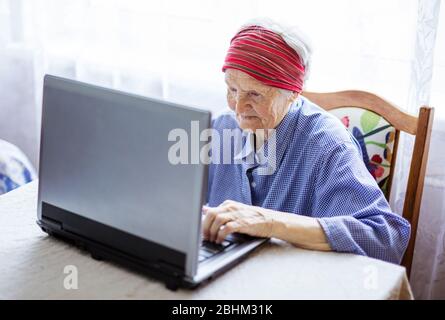 Senior woman using laptop computer at home Stock Photo