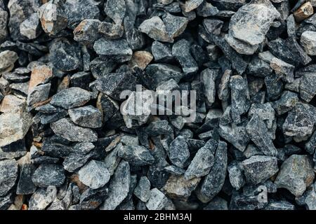 Rough stones, crushed stone, granite gravel close-up. The rough texture of the stone. Building material background. Texture Stock Photo