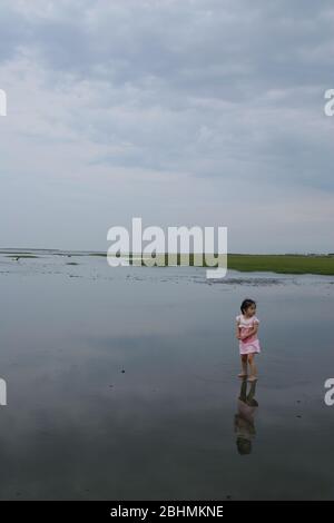 Taichung, MAY 9, 2008 - Young girl playing in Gaomei Wetlands Stock Photo