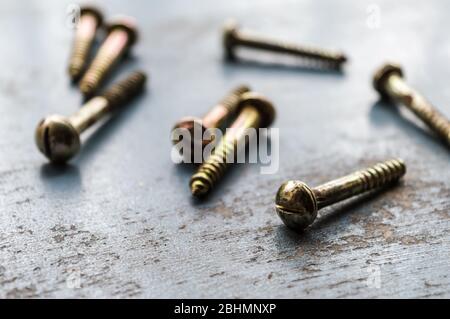 Screw on rusty metallic surface. Close Up. Screws Industrial Background Texture. Selective focus. Business Industry concept. Copy space. Stock Photo