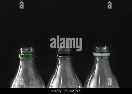 A Close up of empty plastic soft drink bottles on a black background Stock Photo