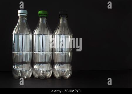 Empty plastic soft drink bottles on a black background Stock Photo