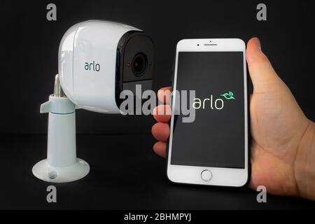 Calgary, Alberta, Canada. April 26, 2020. An Arlo security camera with an iPhone Plus hold by a person using the Arlo aplication Stock Photo