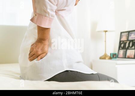 Back pain of old woman at home, healthcare problem of senior concept Stock Photo