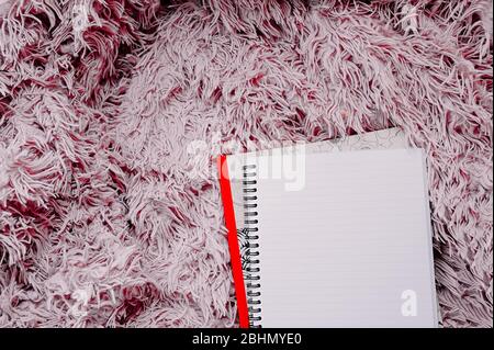 open empty large notebook on a spiral on a pink fluffy blanket. Stock Photo