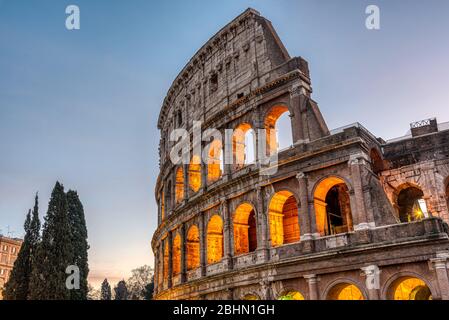 Detail of the illuminated Colosseum in Rome at dawn Stock Photo