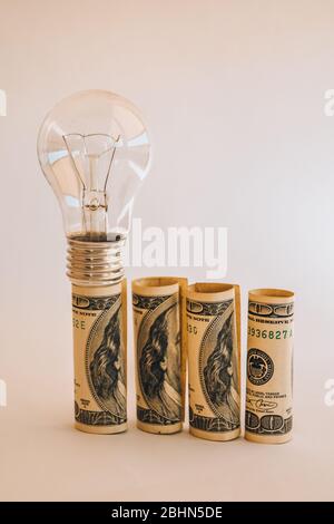 Money saved in different kinds of light bulbs, Lamps on the usd american dollar background Stock Photo