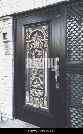beautiful oriental style entrance door of white brick house Stock Photo