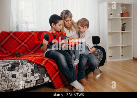 Happy birthday day. Cute kids congratulates mother and gives a gift Stock Photo