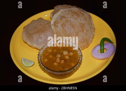 Hot Delicious Indian Bengali Dish Luchi with Ghugni or Chole. Luchi is also termed as Indian Poori or puri . It is traditional Bengali food or Cuisine Stock Photo
