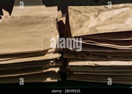 Texture of brown cardboard and craft paper. Wavy paper texture on sunlight. Stock Photo