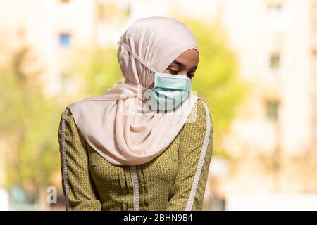 Young Muslim Woman Praying in Mosque With Surgical Mask and Gloves Stock Photo