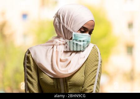 Young Muslim Woman Praying in Mosque With Surgical Mask and Gloves Stock Photo