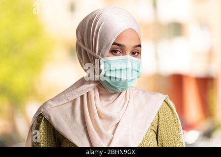 Young Muslim Woman Praying in Mosque With Surgical Mask and Gloves Stock Photo