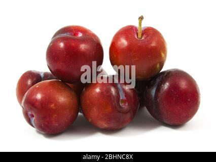 ripe purple cherry plums isolated on white Stock Photo
