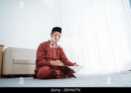 Muslim men learning of Quran at spare time in the home Stock Photo