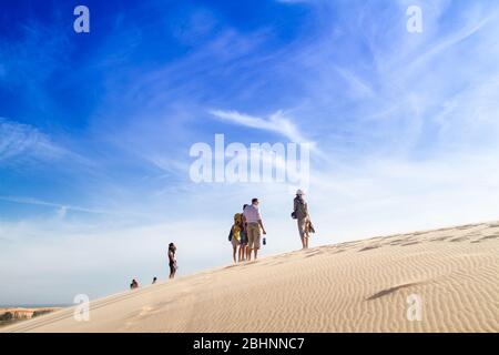 2015-01-03 Vietnam, region Mui Ne. People stand on the crest of a dune. Stock Photo