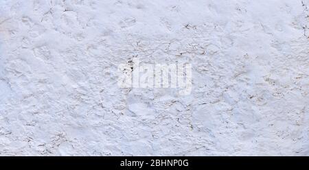 Structure of a very rough, white painted wall Stock Photo