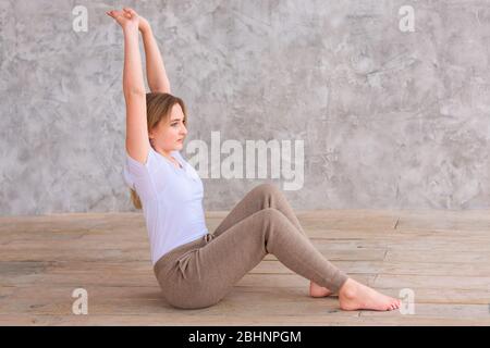 Tennage girl doing fitness gymnastics at home. Gymnastics video tutorial. Gymnastic exercises. Children's activity in quarantine during coronavirus pa Stock Photo