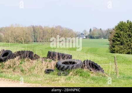 Used old tires near a farmyard in the countryside in Rhineland-Palatinate, Germany, Western Europe Stock Photo