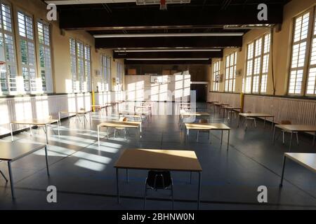 Jena, Germany. 27th Apr, 2020. Empty chairs and tables can be found in a gymnasium in the JenaPlan School that has been converted into a classroom. After a compulsory corona break of several weeks, the schools will reopen on 27.04.2020 for high school graduates. Credit: Bodo Schackow/dpa-Zentralbild/dpa/Alamy Live News Stock Photo