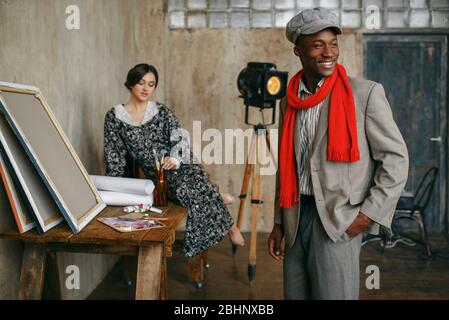 Portrait painter and female model in art studio Stock Photo