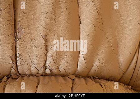 Cracked beige leather texture. Background in bad condition. Stock Photo