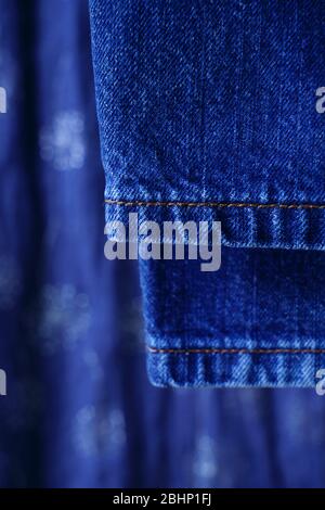 Close up detail of blue denim jeans with blurred background. Stock Photo