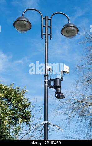A surveillance CCTV camera on a rotating swivel mount with a wireless link to the base station for remote security monitoring. Stock Photo