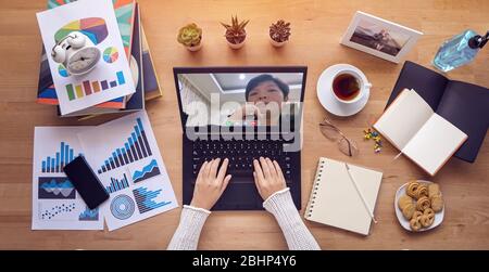 work from home. people make video conference with colleague via laptop computer during self isolation to avoid spreading illness transmission of COVID Stock Photo