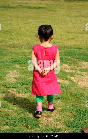 Nathdwara, Rajasthan, India, Asia - Jan. 23, 2014 - Three years old Indian little cute girl walking in the park Stock Photo