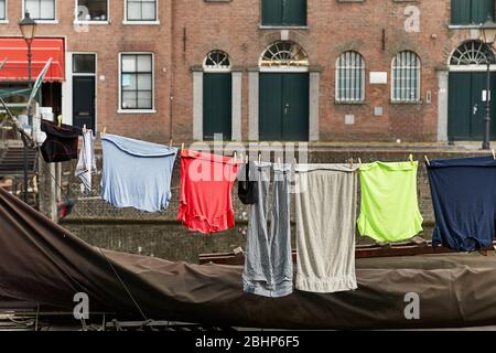 Clothes Hanging Outside near a canal Stock Photo