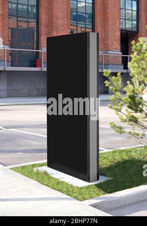 Blank black vertical pylon stand mockup brick building, side view Stock Photo
