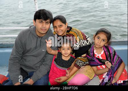 Nathdwara, Rajasthan, India, Asia - Jan. 23, 2014 - Indian family father, mother with two little cute girl traveling in the boat Stock Photo