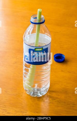 Plastic straw in plastic bottle. Plastic waste concept. Stock Photo