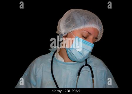 Isolated image of doctor or nurse sleep. Coronavirus COVID-19 pandemic. Tired, exhausted woman in uniform is sleeping in hospital or clinic after hard Stock Photo
