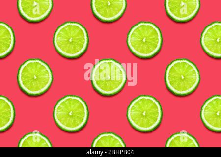 Lime slices seamless pattern on Crimson pink background. Minimal summer concept. Flat lay, trendy juicy color. Stock Photo