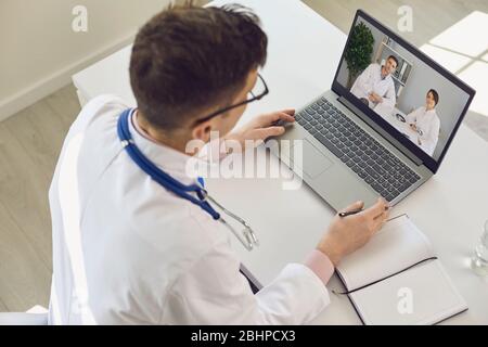 Group of doctors video call conference to doctors sitting in clinic office. Stock Photo