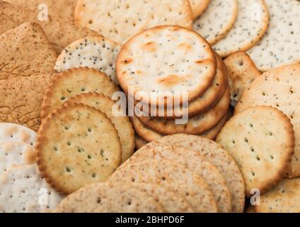 Various organic crispy wheat, rye and corn flatbread crackers with sesame and salt. Macro Stock Photo