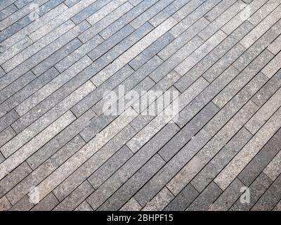 Natural stone granite floor tile pavement. Full frame diagonal lined abstract background texture. Stock Photo