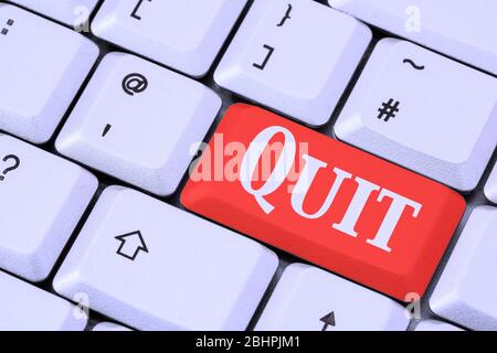 A keyboard with the word QUIT on a red enter key. Quitting or giving up something concept. England, UK, Britain Stock Photo