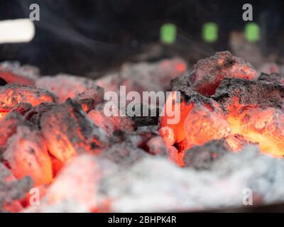 Close-up of charcoal burning flameless in barbecue grill or fireplace. Stock Photo