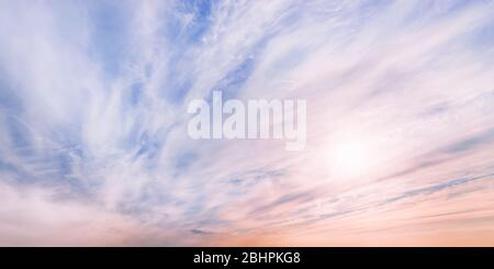 Large dramatic pastel colored cloudscape at sunset. Wide angle view of evening sky Stock Photo