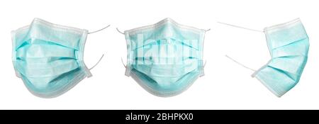 Set of green medical and surgical masks that protect against viruses in a pandemic isolated on a white background. Collection of cut mask at different Stock Photo