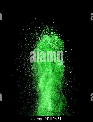 Vertical green powder splash or explosion on a black background. Stock Photo