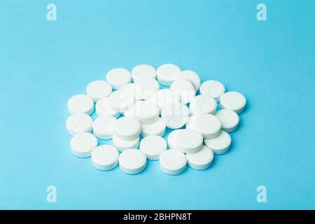 Pills background. Pills, drags and medecine concept. White tablets on a blue background Stock Photo