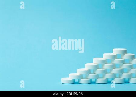 Pills background. Pills, drags and medecine concept. White tablets on a blue background Stock Photo